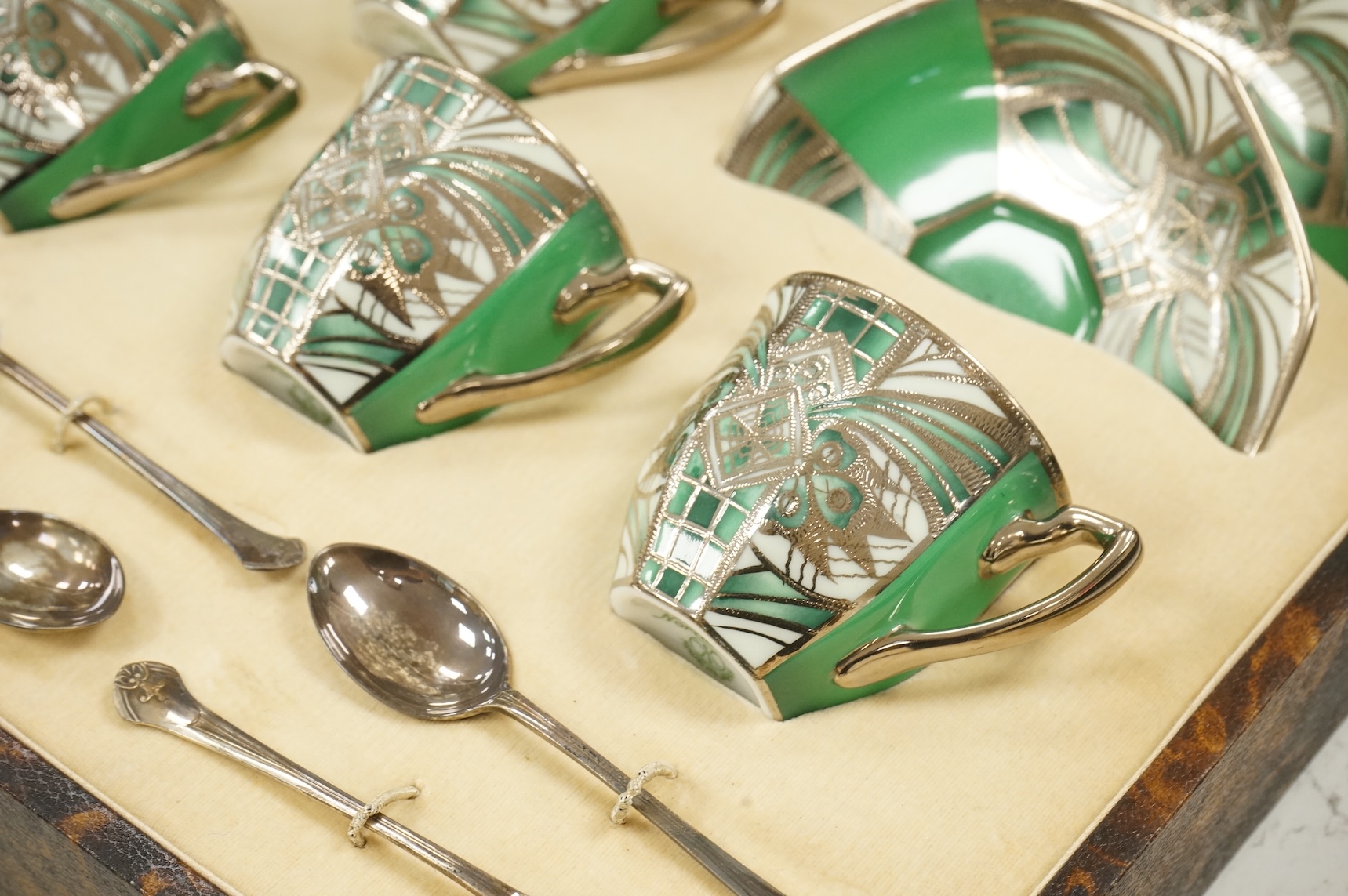 A Noritake coffee set, six-place setting including silver spoons, Sheffield 1932